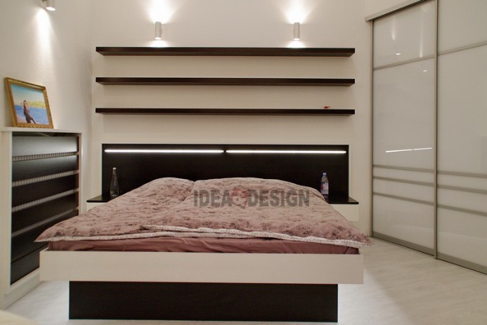 Photo of a double bed with lighting in the headboard